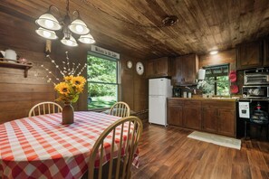 Large eat-in kitchen with natural and electric lighting 