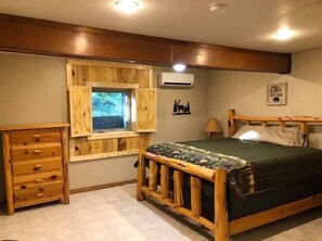 Master bedroom with a king bed located on the basement floor