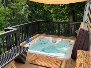 Private sunken hot tub overlooking the woods and creek open year round