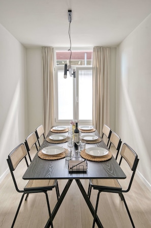 After cooking a delicious dinner, head on over to the 6-seater elegant dining table with wine glasses, plates and silverware.