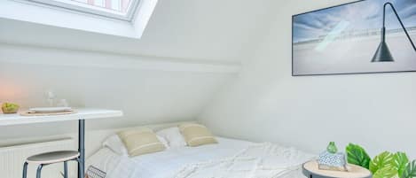 The bedroom has a skylight installed, allowing tons of beautiful natural light to fill up the space.