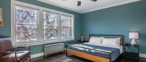 King bedroom with Roku TV, ceiling fan, large closet and windows