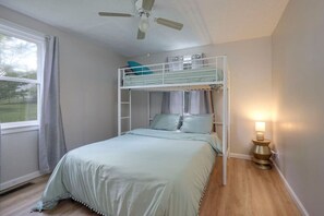 Room with a double and single loft bed.