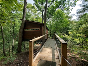 Exterior front view, ramp to access the treehouse.