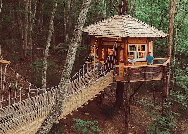 Walk across the suspension bridge to your treehouse