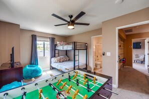 Upstairs guest room, perfect for kids! Full size bottom bunk + twin size top bunk beds. Foosball table, hallway shelves full of board games, fuzzy bean bag chairs + smart TV. Closet and dresser storage with in-suite full bathroom.