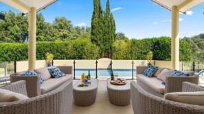 outdoor dining and entertainment area of south coast accommodation overlooking a pool