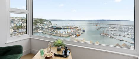 Living room window offering stunning views of Brixham harbour and beyond.