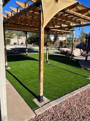 Brand new turf is the perfect spot to play on! A shaded area off the patio for outdoor dining.