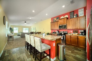 Whip up something delicious in this vibrant, fully-stocked kitchen with bar seating perfect for morning chats or evening wine -- your home-cooked memories start here!