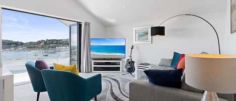 Stylish living room with bi-fold doors leading out to the balcony