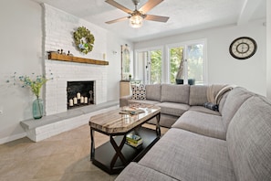 Lower level living room. This living room now has a Smart TV above the mantle (streaming only)