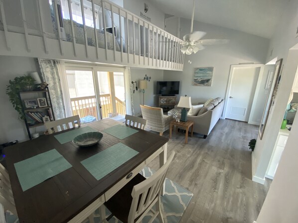 Open living/dining area with loft