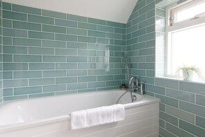 Relax in the marine blue family bathroom.
