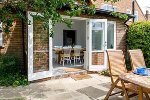 Open the patio doors to the pretty garden.