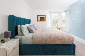 One of the king size bedrooms with a large picture window and ensuite bath with walk-in shower.