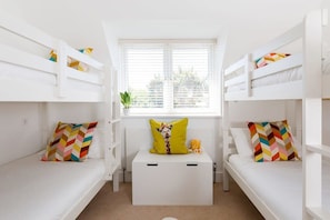 The home is designed for families, best visible in the two bunk bedrooms