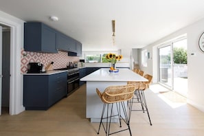 The open plan kitchen/living/dining area is light, airy and modern.