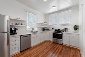 Spacious kitchen equipped with cooking basics