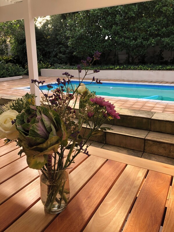 Portch with heated swimming pool and table