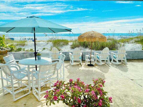 CAFE STYLE TABLE AND CHAIRS FOR ENJOYING A MEAL OUT IN THE OCEAN AIR.