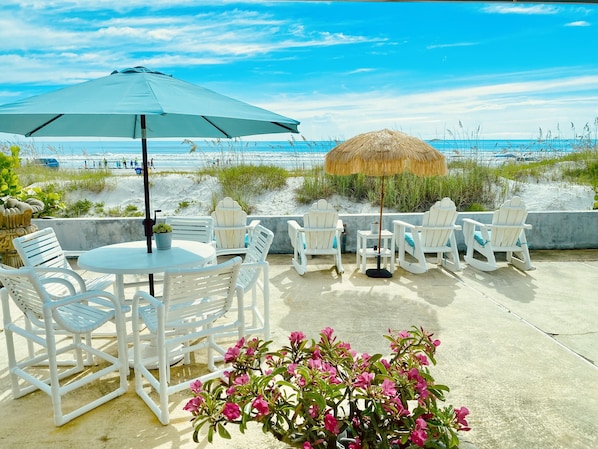 CAFE STYLE TABLE AND CHAIRS FOR ENJOYING A MEAL OUT IN THE OCEAN AIR.