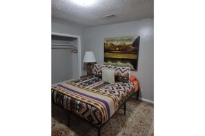 master bedroom with queen size bed ,full bath and smart tv