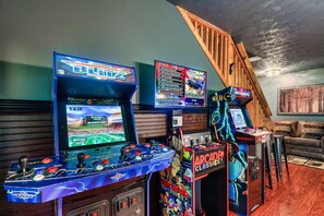 [Game room / Lower Level] Game room fun awaits! Dive into over 3,000 arcade games and pool in our cozy nook. The ideal place to bond and create lasting memories after a day of exploration.