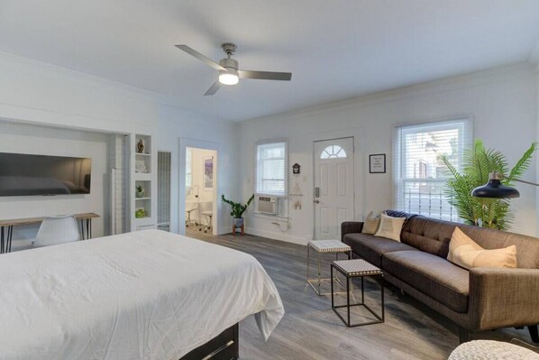 Spacious bedroom with your own TV and sofa perfect for relaxation and binge-watching.