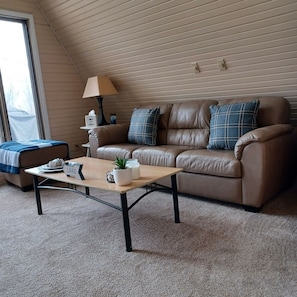 Nice leather furniture in living room.  Pillows have removable covers to launder