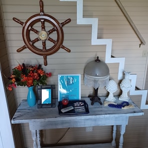 Guest Book, WIFI info, device charging station and key on table in dining area
