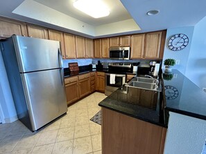 Well stocked kitchen with plenty of dish-ware, coffee maker and dish detergent.