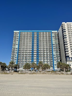 Literally steps away from the beach! Our condo is center and 8 floors up.