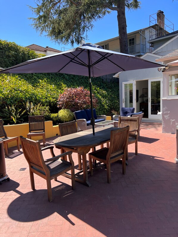 Outdoor patio with picnic table for 6, grill and heat lamps.