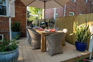 Gorgeous teak table with stylish chairs on back deck.  Enjoy having a glass of wine or barbecue dinner!