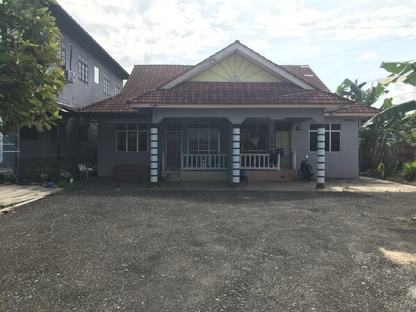 Infront of the house. Huge parking space or playground for kid