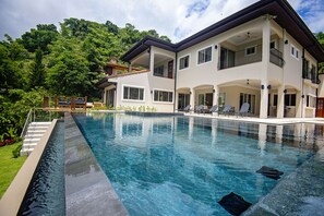 Large pool area, outdoor dining area and lounge area.