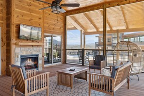 Relax on the large screened-in patio complete with TV and fireplace after a day of exploring the top local attractions in Gatlinburg, Pigeon Forge, and Townsend | Woodland Cove in Sevierville, TN