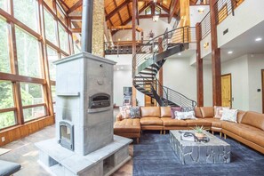 Grand living room with 40 ft vaulted ceilings and a wall of windows.