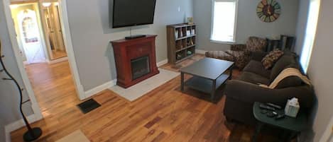 Living Room from front door. Pull out couch, big comfy chair, flat screen, fireplace, games, books, dvd's and toys!