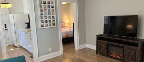 Living Room with door ways to Kitchen and Bedroom