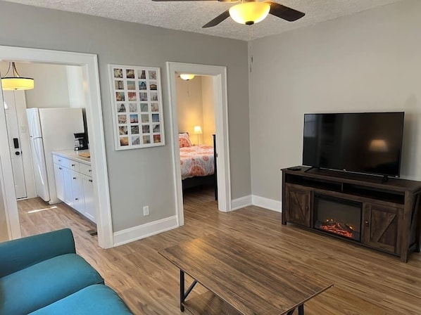 Living Room with door ways to Kitchen and Bedroom