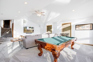 Lower level game room with pool table and basketball game