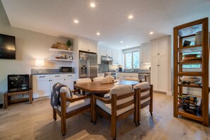 Dining table seats 6.  Below the Smart TV is a wine refrigerator.