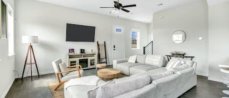 cozy modern living room with sectional couch and throw blankets and games