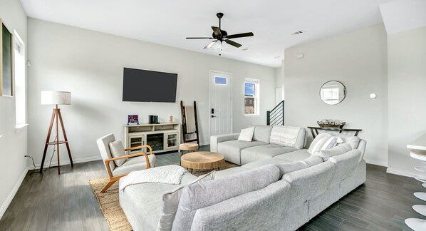 cozy modern living room with sectional couch and throw blankets and games