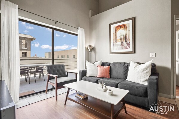 Living room with sleeper sofa and smart TV and patio access