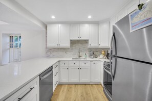 Newly remodeled with stainless steel appliances and peninsula with barstools.