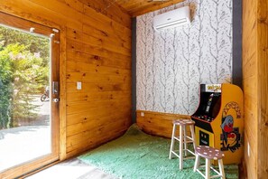 Unleash your inner child with retro arcade fun and serene leafy views!