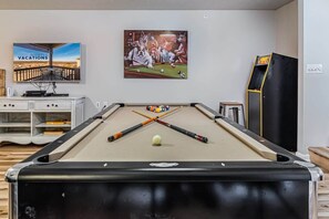 Hours of fun in the game room with a pool table and arcade game!